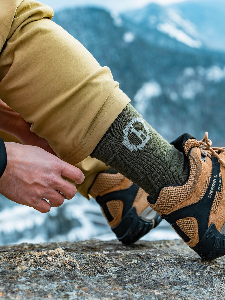 Andean Moss / Green Alpaca Wool Crew Sock on Right Foot Worn with Merrell Hiking Boots – PAKA Apparel