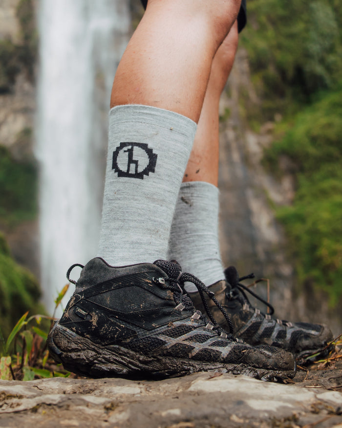 Light Grey Moisture-Wicking Alpaca Wool Crew Socks Worn with Hiking Boots in Front of Waterfall – PAKA Apparel