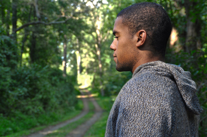 Male Model wearing the Vida in front of green trees