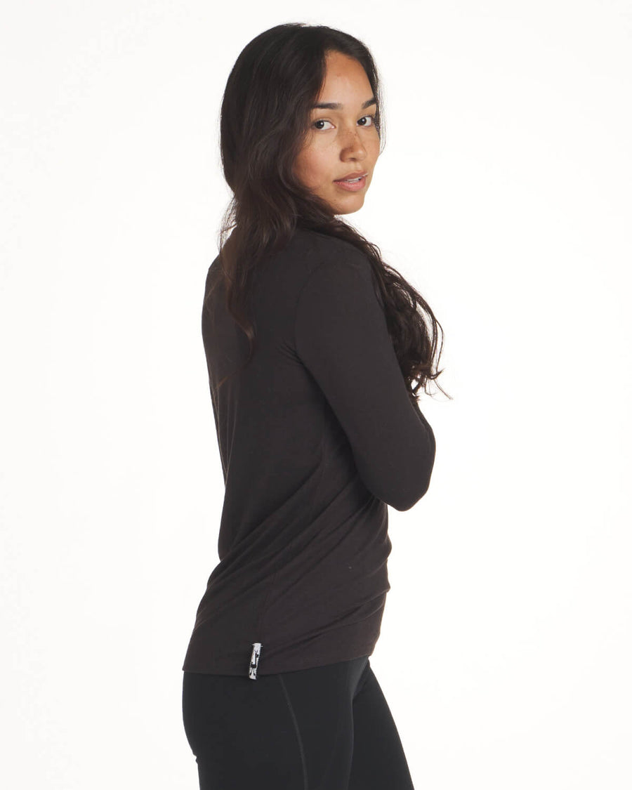 Woman Standing Sideways with Arm Crossed in Black Everyday Sustainable Alpaca Wool Baselayer Top – PAKA Apparel