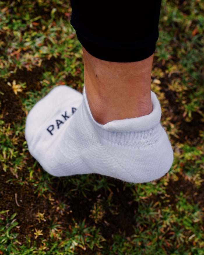 Left Foot Stepping on Grass Wearing White Alpaca Wool Outdoor Ankle Sock – PAKA Apparel