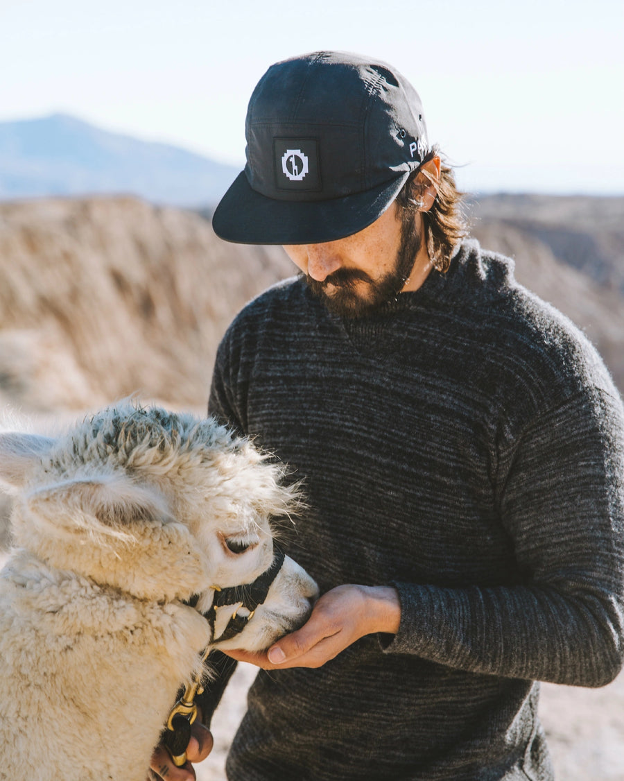 Man in The Hoodie Charcoal / Dark Grey Alpaca Natural Fiber Hoodie Sweater Feeding an Alpaca in Peru Mountains – PAKA Apparel