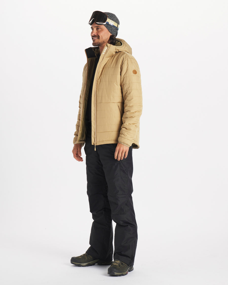 Model in Ski Goggles and Hat Wearing Apu Tan Men’s Midweight Puffer Jacket with Sustainable PAKAFILL® Alpaca Insulation – PAKA Apparel