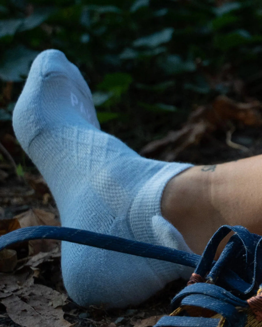 Right Foot of Woman Wearing Lichen / Light Blue Alpaca Wool Ankle Sock Next to Laces of Running Shoes – PAKA Apparel