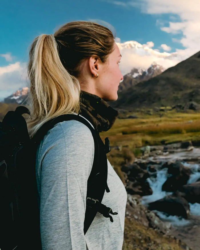 Women Wearing Heather Grey Everyday Alpaca Wool Baselayer While Hiking with Pack in Mountains – PAKA Apparel