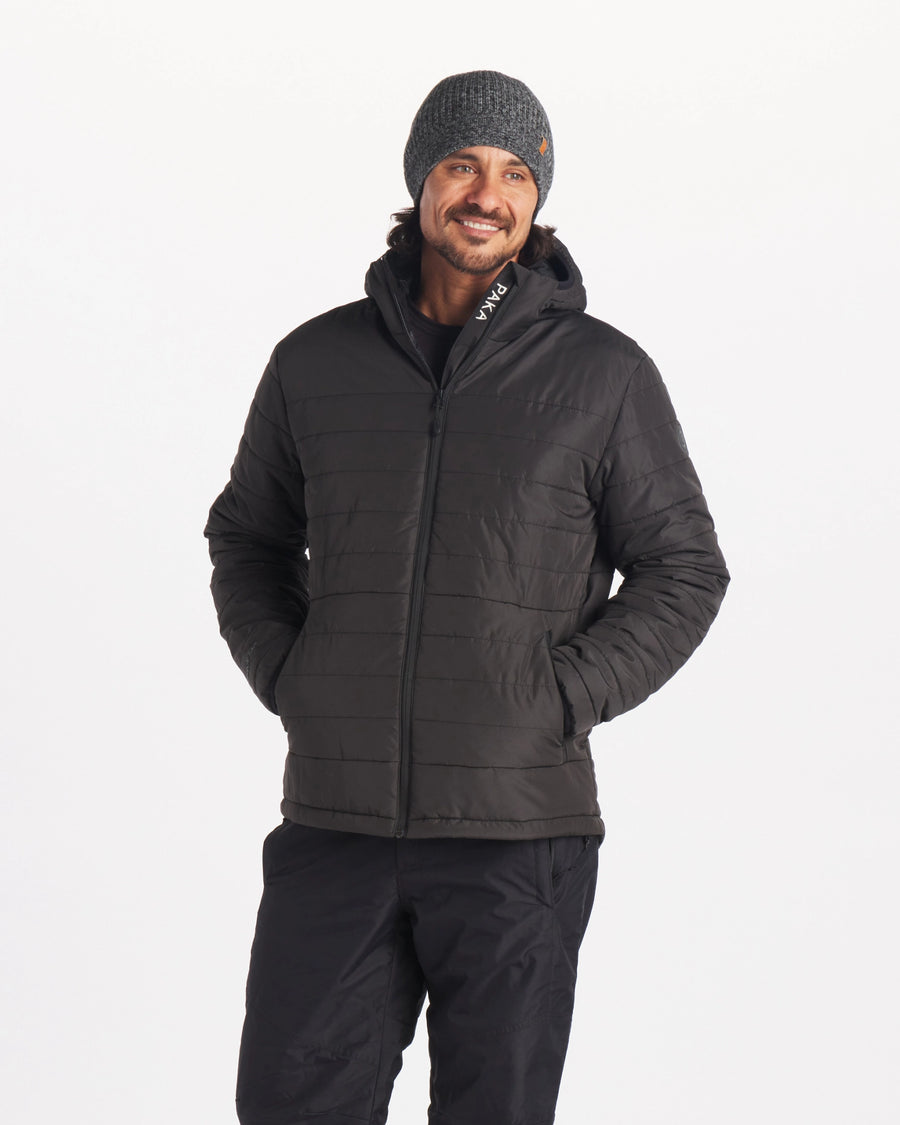 Male Model in Ski / Snow Pants Wearing Apu Matte Black Men’s Midweight Puffer Jacket with Natural Fiber PAKAFILL® Alpaca Insulation – PAKA Apparel