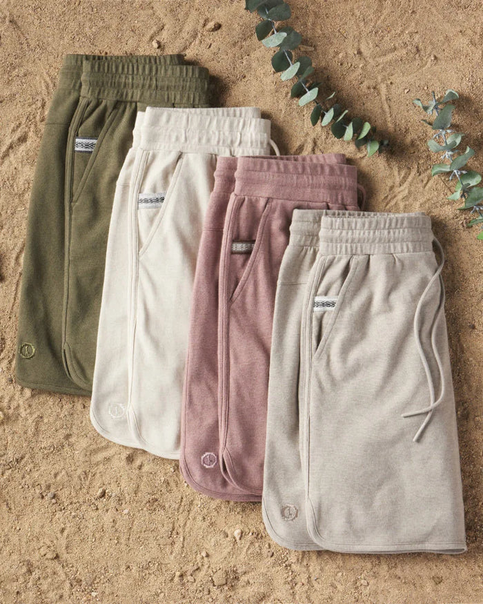 Editorial shot of mens alpaca terry shorts green, cream, pink and grey 